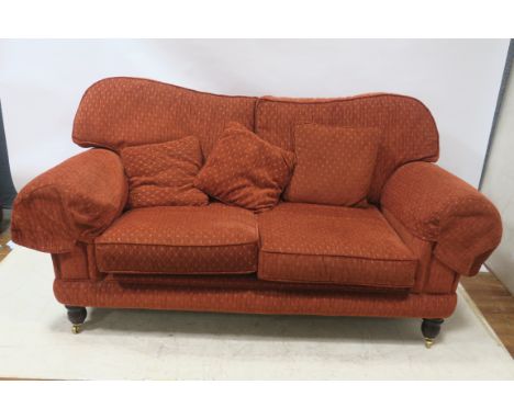 A CONTEMPORARY SOFA of rectangular form the close upholstered frame with scrolled arms fitted with loose back and seat cushio