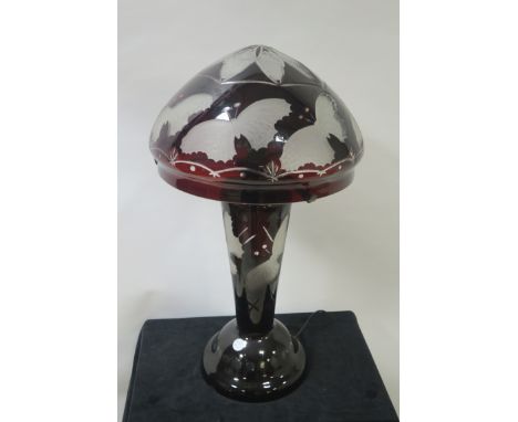 AFTER EMILE GALLE, a ruby and clear glazed table lamp decorated with butterflies, the dome shade on a circular tapering stem 