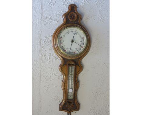 AN EDWARDIAN OAK CARVED BANJO SHAPED BAROMETER, 88cms x 32cms