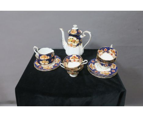 A ROYAL ALBERT  BONE CHINA TEASET (HEIRLOOM PATTERN), the white ground decorated with blue foliate filled borders with gilded