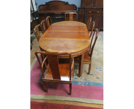 A GOOD ORIENTAL HARDWOOD NINE PIECE DINING SUITE comprising eight chairs including a pair of elbow chairs each with a solid v