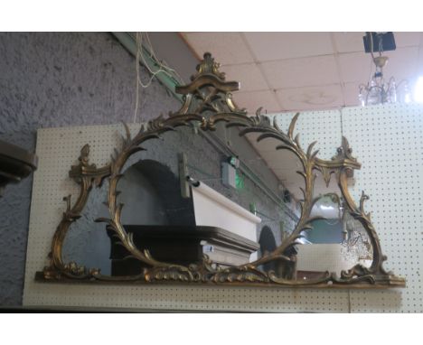 A GILT FRAMED CHIPPENDALE STYLE COMPARTMENTED MIRROR, the scrolled frame headed by a shell and scrolled cartouche
