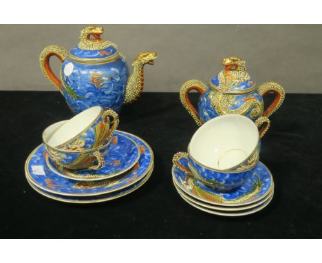 AN ORIENTAL STYLE GLAZED PORCELAIN PAINTED AND ENAMELLED COFFEE SET, comprising  a coffee pot two handled sugar bowl four cup