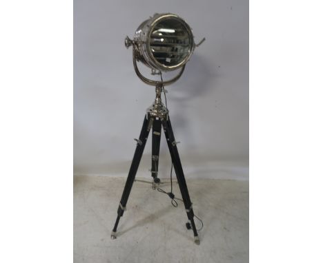 A CHROME FRAMED STANDARD LAMP, in the form of a ships light shown standing on a tripod base 145cms high