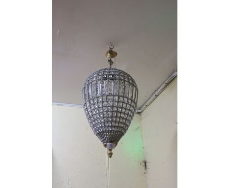 A CONTINENTAL GILT BRASS AND CUT GLASS SILVERED CENTRE LIGHT, of ovoid form decorated with facetted pendants.
