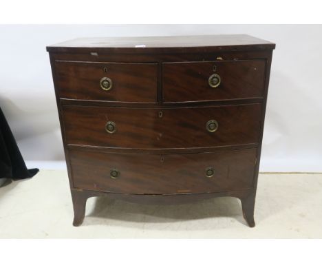 AN EARLY 19TH CENTURY MAHOGANY BOWED CHEST OF DRAWERS the rectangular top above two short and two long drawers, brass drop ha