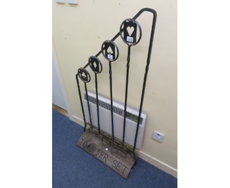 AN EARLY 20th CENTURY METAL FRAMED STANDING "TOASTER SET", the open tubular frame fitted with four double pronged forks, the 