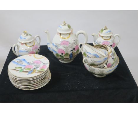 AN ORIENTAL STYLE GLAZED AND PAINTED PORCELAIN TEASET, comprising  tea cups,  sugar bowl, saucers, side plates, creamer and t