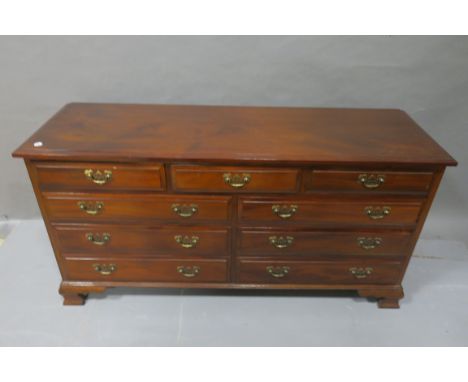 A GEORGIAN STYLE MAHOGANY CHEST, rectangular top with moulded rim above three frieze drawers and six long drawers pierced bra