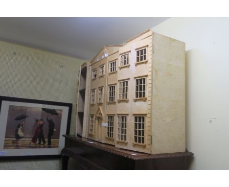 A GEORGIAN STYLE DOLLS HOUSE, the arched pediment centred by a foliate motif above four hinged doors fitted with mock windows