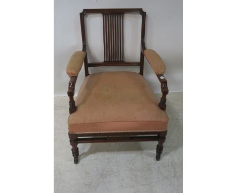 A 19TH CENTURY MAHOGANY CARVED OPEN ARMCHAIR, rectangular back with horizontal pierced splat padded arm rests deep cushion se