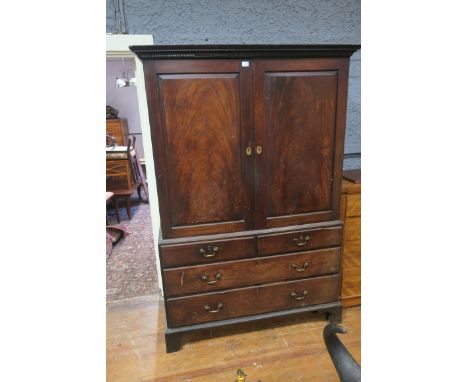 A 19TH CENTURY MAHOGANY LINEN PRESS, the moulded cornice above a dental frieze with a pair of fielded panelled doors revealin