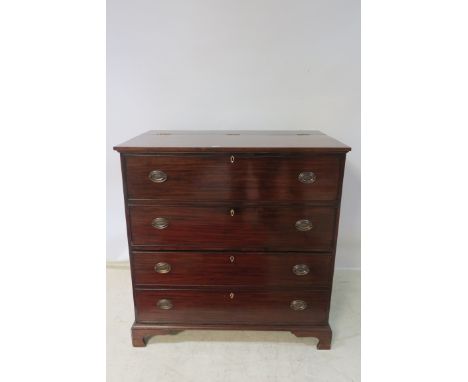 A GEORGIAN STYLE MAHOGANY CHEST, the rectangular hinged top lifting to reveal a deep cupboard, the front with two faux and tw