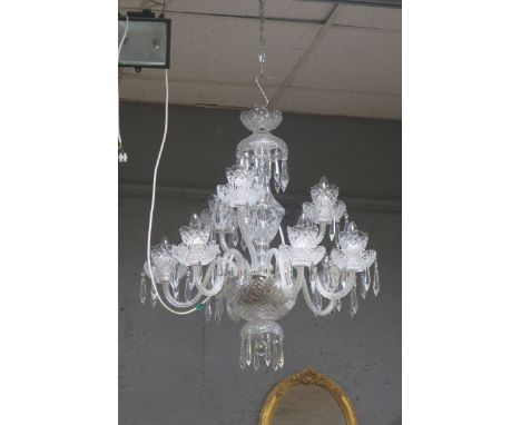 A CUT GLASS EIGHT LIGHT CHANDELIER, the circular corona hung with pendent drops above the diamond cut stem the circular bowl 