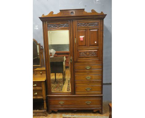 AN EARLY 20TH CENTURY GEORGIAN STYLE MAHOGANY CARVED WARDROBE, the lozenge carved cornice with scrolled ends centred by a fol