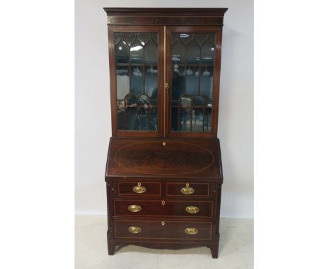 A GEORGIAN STYLE MAHOGANY AND MARQUETRY INLAID BUREAU BOOKCASE, the moulded cornice above a pair of arched glazed doors with 