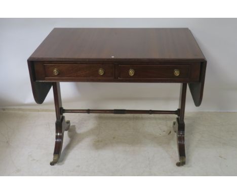 A REGENCY STYLE MAHOGANY DROP LEAF SOFA TABLE, 20th century rectangular top with reeded rim above two frieze drawers brass ci