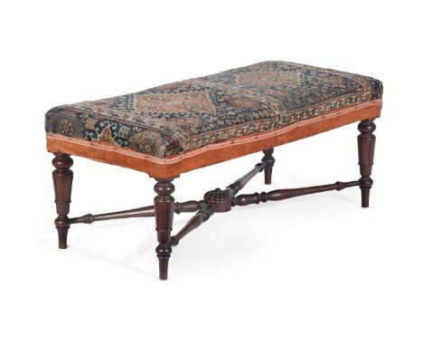 AN EARLY VICTORIAN MAHOGANY AND CARPET UPHOLSTERED STOOLCIRCA 1840The Persian carpet fragment above lappet carved tapering su