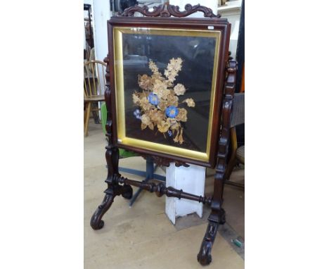 A 19th century rosewood firescreen, with a floral decorated glazed panel, raised on pierced supports, W122cm 