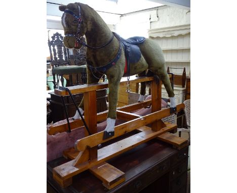 A Vintage upholstered rocking horse on pine frame, H125cm 