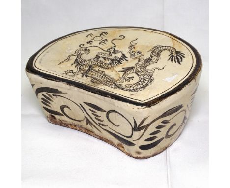 A ceramic Chinese pillow with dragon decoration, 23cm across 