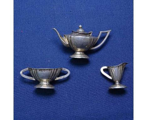 A George V miniature 3-piece silver teaset, comprising teapot, sugar bowl and cream jug, by Levi &amp; Salaman, hallmarks Bir