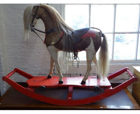 An Antique hide rocking horse, on painted sled base, H90cm 