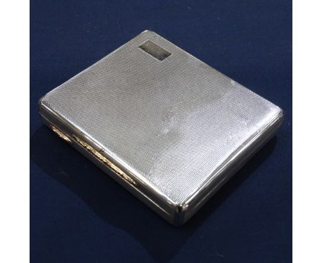 An engine turned square shallow silver box with gold thumb piece, 4 1/2oz, London 1946 
