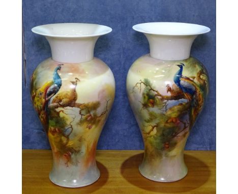 A pair of Royal Worcester vases, with design of peacocks in a pine tree, height 31cm 
