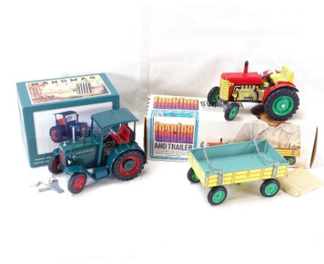 A Hanomag R40 clockwork tinplate tractor, and an S Valnikem clockwork tinplate tractor and trailer, both boxed with keys (2) 