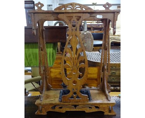 A small Arts and Crafts oak stick stand, with carved and pierced panel decoration, W44cm, H59cm 