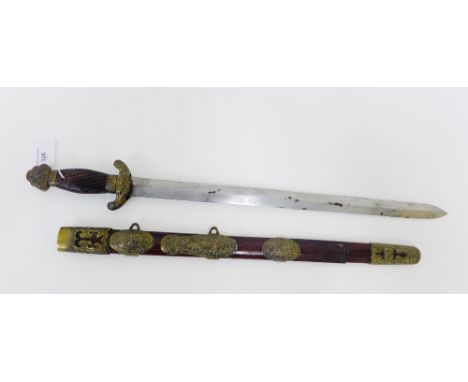 A Chinese short sword with stained wood and brass mounted handle complete with scabbard, length overall 65cm