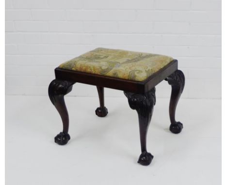A 19th century mahogany stool. the floral upholstered top on carved leaf supports with claw and ball feet,  46 x 60cm 