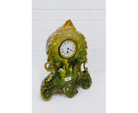 A pottery Rococo style mantle clock with swan and lake pattern, the enamel dial with Roman numerals, 44 x 34cm 