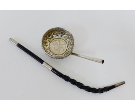 A coin set punch ladle, unmarked,  and a white metal mounted twisted whale bone handle (a/f) 