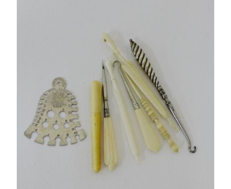 A mixed lot to include a crochet hook, needle cases, needle size markers, button hooks, etc (a lot) 
