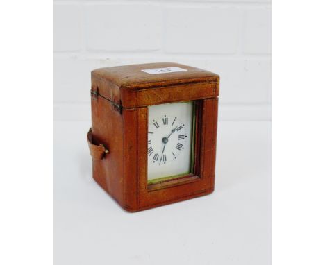 A small brass carriage clock complete with leather outer carrying case, 13cm high