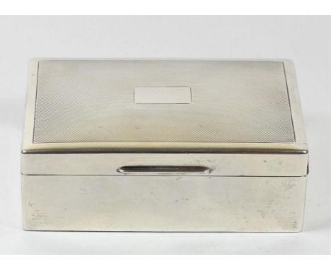 A silver cigarette box, Birmingham 1945, with engine turned decoration, vacant cartouche, cedar lined, 14 x 9 x 5cm 