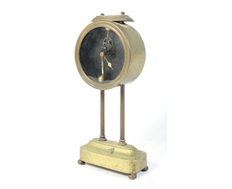 A 1920s gravity powered desk clock, by Kee-Less Clock Company, glass dial in brass case, pendulum &amp; dead-beat escapement 