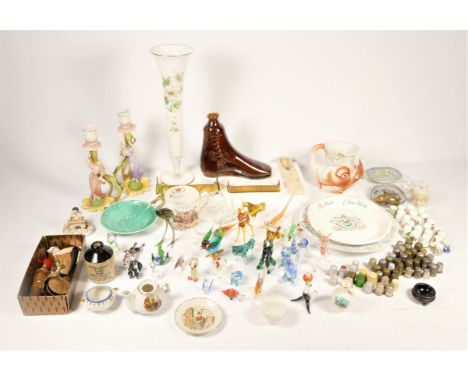 A collection of thimbles, together with a collection of miniature glass animals, an early pair of ceramic figural candle stic