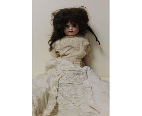 A VINTAGE GERMAN BISQUE HEADED DOLL IN VINTAGE DRESS