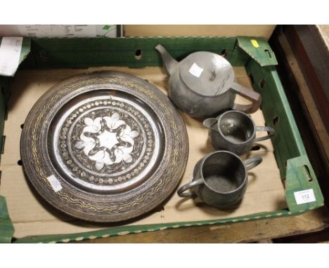A HAMMERED FINISH PEWTER THREE PIECE TEA SERVICE, TOGETHER WITH A BRASS INLAID CARVED WOODEN CHARGER 
