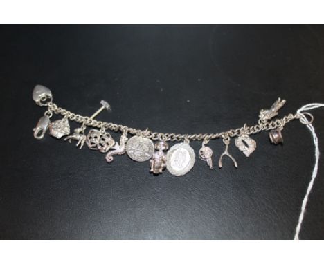 A VINTAGE SILVER CHARM BRACELET 