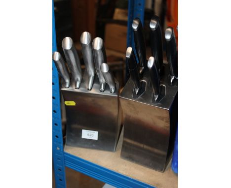 A SET OF BLACK HANDLED SABATIER KITCHEN KNIVES WITH SELF SHARPENING KNIFE BLOCK, TOGETHER WITH A SIMILAR SILVER HANDLED SET