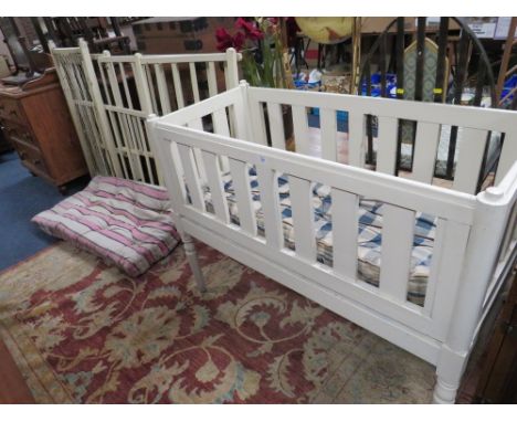 A VINTAGE WHITE PAINTED CHILDS COT TOGETHER WITH AN EDWARDIAN FOLDING EXAMPLE PLUS ANOTHER PAINTED EXAMPLE (3)