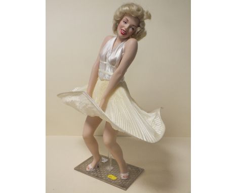A CERAMIC FIGURE OF MARILYN MONROE ON STAND  H- 42CM 