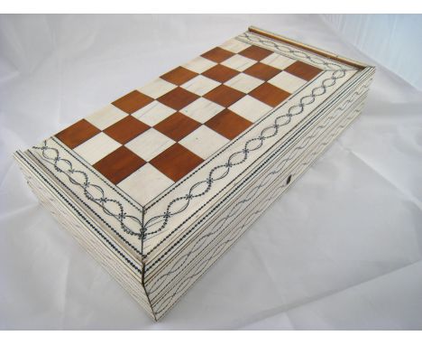 A 19th. century ivory, ebony and hardwood games box , when opened  the outside forming a chess board, the inside a backgammon