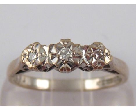  An 18 carat white gold three stone diamond ring, size N, 2.9 gms.