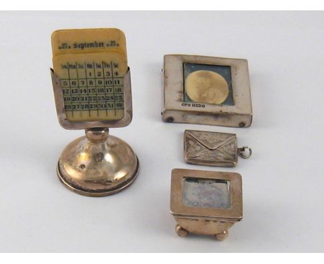 A silver mounted perpetual calendar, Birmingham, 1905,  a silver framed portrait paperweight, Birmingham 1901, a stamp box, L