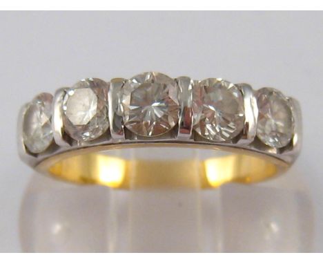 A yellow metal (tests 18 carat gold) five stone diamond ring, the round brilliant cut diamonds of good colour and clarity est